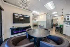 A beautifully arranged charcuterie board featuring salami, breadsticks, nuts, and dried fruit.